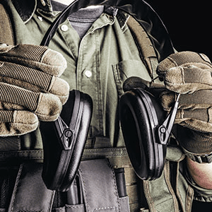 Soldier Holding Earmuffs