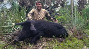 Man Showing Off His Feral Hog Kill