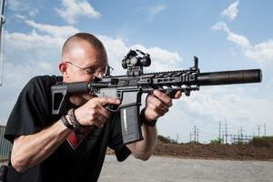 Man With a Suppressed AR Pistol