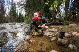 hiker using water filtration system